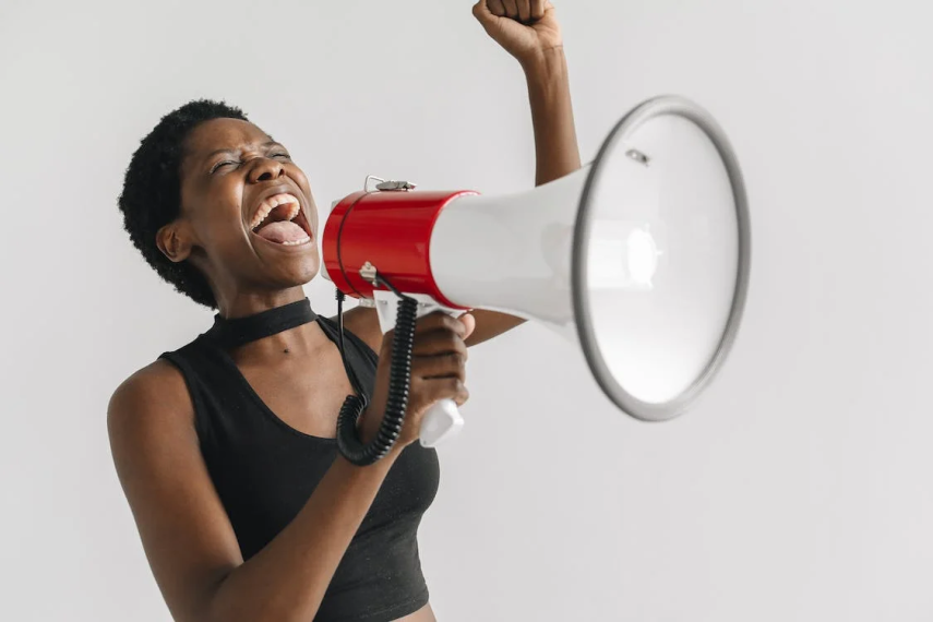 a woman shouting into a megaphone